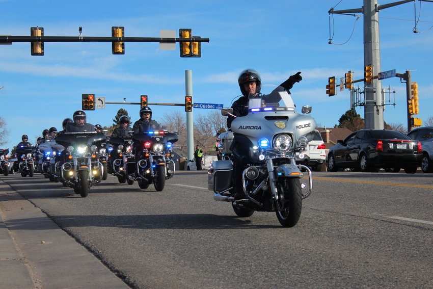 A procession for Troy Jackson, a former assistant chief for South Metro Fire Rescue, drives through Centennial at Quebec Street and Dry Creek Road Dec. 20.
